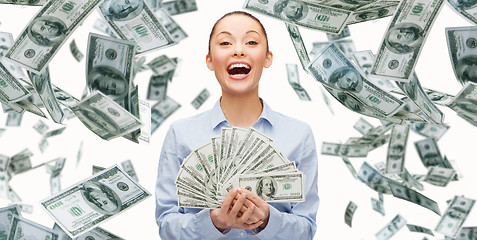 Image showing smiling businesswoman with dollar cash money