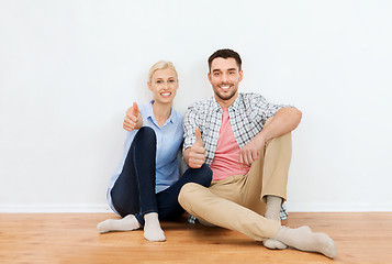 Image showing happy couple showing thumbs up at new home