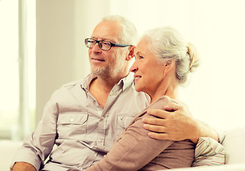 Image showing happy senior couple sitting on sofa at home