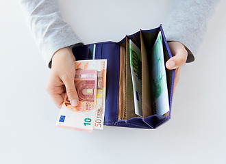 Image showing close up of woman hands with wallet and euro money