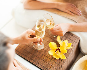 Image showing woman and man hands with champagne glasses