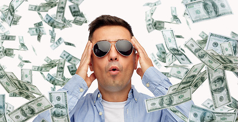 Image showing surprised man under dollar money rain