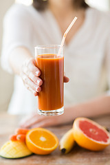 Image showing close up of woman hands with juice and fruits