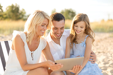 Image showing smiling family at beach with tablet pc computer