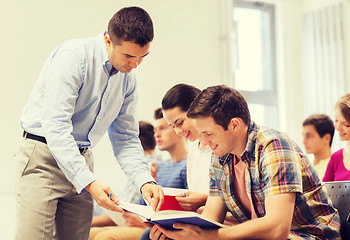 Image showing group of students and teacher with notebook