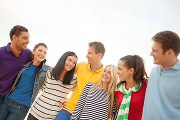 Image showing group of happy friends hugging and talking