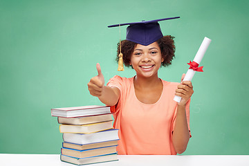 Image showing happy african bachelor girl with books and diploma