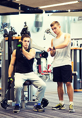 Image showing men exercising on gym machine