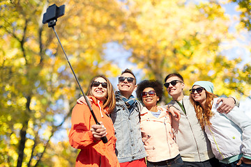 Image showing smiling friends taking selfie with smartphone