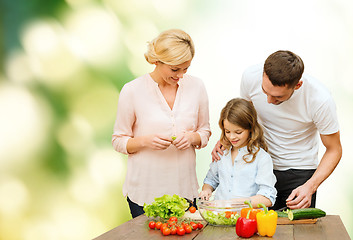 Image showing happy family cooking vegetable salad for dinner