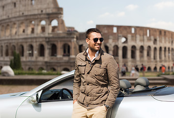 Image showing happy man near cabriolet car over coliseum