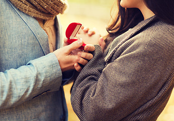 Image showing close up of couple with gift box in park