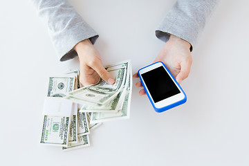 Image showing close up of woman hands with smartphone and money