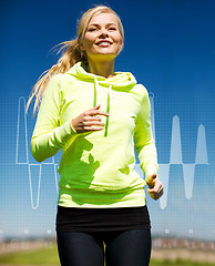 Image showing smiling woman jogging outdoors