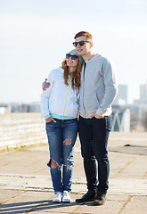 Image showing happy teenage couple walking in city