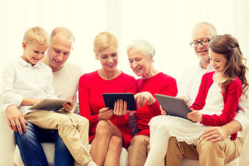 Image showing smiling family with tablet pc computers at home