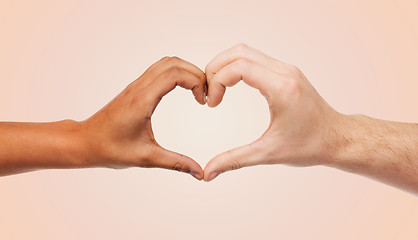 Image showing woman and man hands showing heart shape