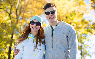 Image showing happy teenage couple walking in autumn park