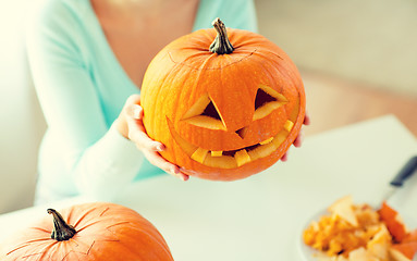 Image showing close up of woman with pumpkins at home