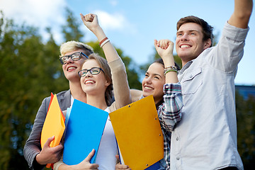 Image showing group of happy students showing triumph gesture