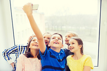 Image showing group of school kids taking selfie with smartphone