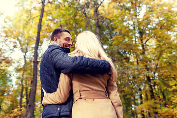 Image showing smiling couple hugging in autumn park