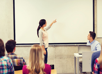 Image showing group of students and smiling teacher in classroom