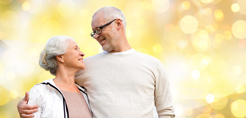 Image showing happy senior couple over holiday lights background