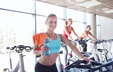 Image showing group of women riding on exercise bike in gym