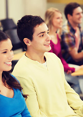 Image showing group of smiling students in lecture hall