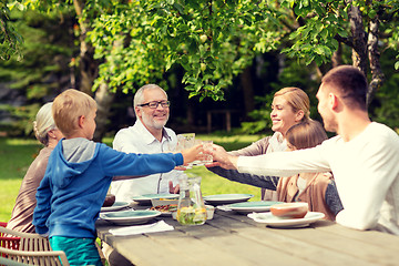 Image showing happy family having holiday dinner outdoors