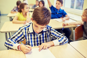 Image showing group of school kids writing test in classroom