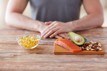 Image showing close up of male hands with food rich in protein