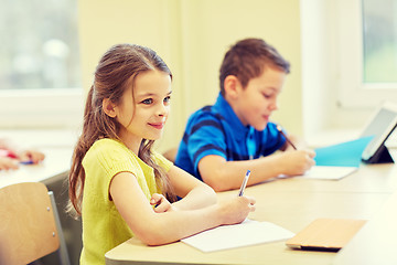 Image showing group of school kids writing test in classroom