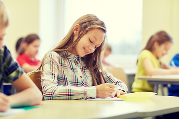 Image showing group of school kids writing test in classroom