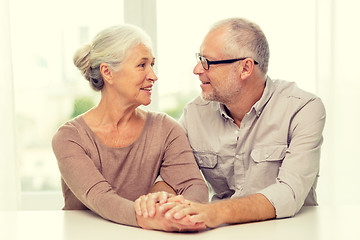 Image showing happy senior couple sitting on sofa at home