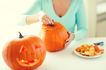 Image showing close up of woman with pumpkins at home