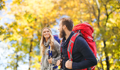 Image showing smiling couple with backpacks hiking