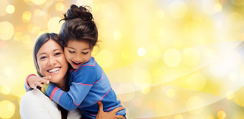 Image showing happy mother and daughter hugging over lights