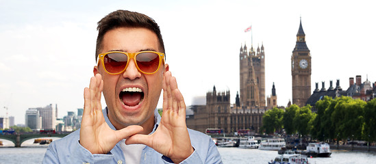 Image showing face of angry shouting man in shirt and sunglasses