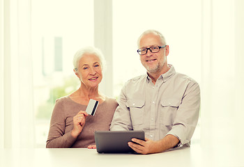 Image showing happy senior couple with tablet pc and credit card