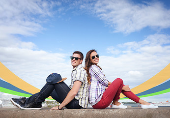 Image showing teenagers sitting back to back