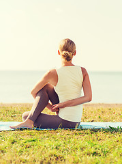 Image showing woman making yoga exercises outdoors