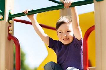 Image showing happy little boy climbing on children playground