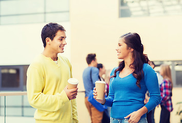 Image showing group of smiling students with paper coffee cups