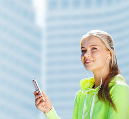 Image showing woman listening to music outdoors