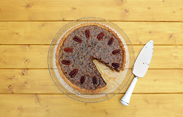 Image showing Slice removed from a pecan pie