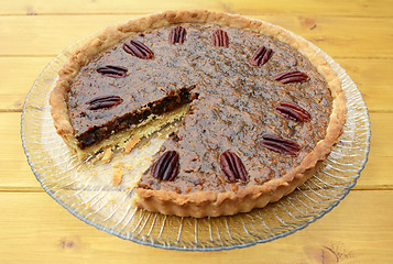 Image showing Pecan pie on a plate with one slice taken