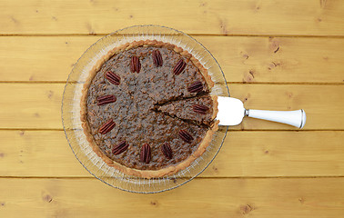 Image showing Pie server with cut slice in a traditional pecan pie