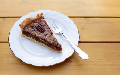 Image showing Slice of pecan pie on a china plate with a fork